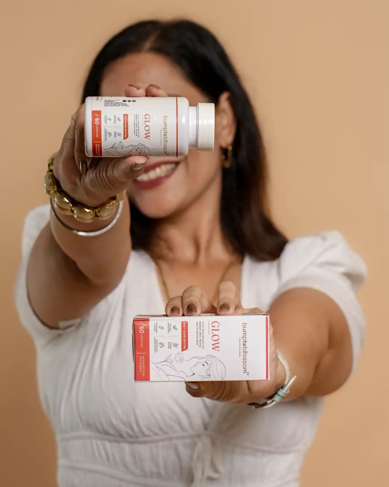 Founder holding Bump to Blossom Glow product